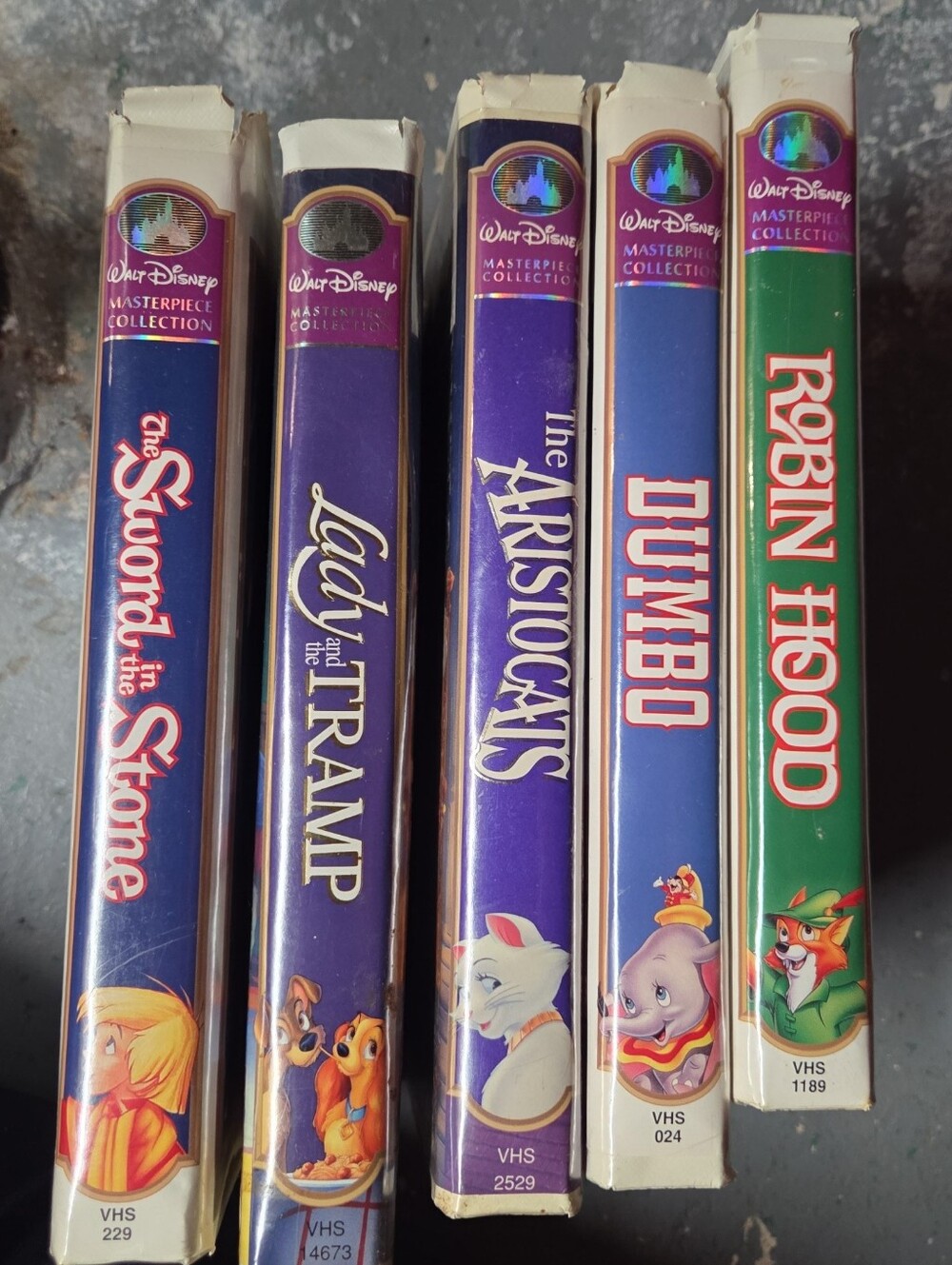 Disney VHS Set Spines in Purple, Blue, Green